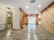 Living area featuring wood-paneled walls and wood-look tile at 70 Horton Cir, Sarasota, FL 34232