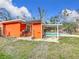 Orange shed and patio with grill near the pool at 70 Horton Cir, Sarasota, FL 34232