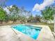 Refreshing blue pool with adjacent spa and fenced backyard at 70 Horton Cir, Sarasota, FL 34232