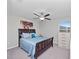 Charming bedroom with a king-size bed and colorful art at 13327 Willow Bluestar Loop, Riverview, FL 33579