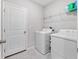 Laundry room with washer, dryer, and shelving at 13327 Willow Bluestar Loop, Riverview, FL 33579