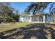 Landscaped backyard with screened porch and large grassy area at 2559 Comet Ln, North Port, FL 34286