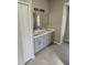 Double vanity bathroom with modern gray cabinets and quartz countertops at 2559 Comet Ln, North Port, FL 34286