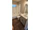 Clean bathroom with tub, shower, vanity, and wood-look floors at 2559 Comet Ln, North Port, FL 34286