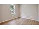 Well-lit bedroom featuring a window and wood-look floors at 2559 Comet Ln, North Port, FL 34286