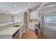 Modern kitchen with white cabinets, stainless steel appliances, and quartz countertops at 2559 Comet Ln, North Port, FL 34286