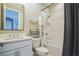 A tidy bathroom featuring a shower and tub combination with all white tile and a white vanity at 4606 Pond Brook Ct, Bradenton, FL 34211