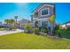 Gray two-story house with stone accents, three-car garage, and lush landscaping at 4606 Pond Brook Ct, Bradenton, FL 34211