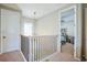 A naturally-lit upstairs hallway with carpet flooring showing access to multiple rooms at 4606 Pond Brook Ct, Bradenton, FL 34211