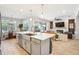 Open-concept kitchen with quartz countertops, stainless steel appliances, and seamless flow into the dining and living areas at 4606 Pond Brook Ct, Bradenton, FL 34211