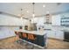 Modern kitchen featuring white cabinets, quartz countertops, and a large island at 4606 Pond Brook Ct, Bradenton, FL 34211