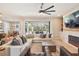 Bright and airy living room featuring an elegant stone fireplace, comfortable seating, and seamless indoor-outdoor flow at 4606 Pond Brook Ct, Bradenton, FL 34211