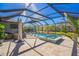 Screened pool and spa with lounge chairs and outdoor seating at 4606 Pond Brook Ct, Bradenton, FL 34211