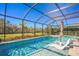 Expansive pool and spa with screened enclosure and lounge chairs at 4606 Pond Brook Ct, Bradenton, FL 34211