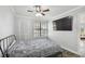 Spacious bedroom with a large TV, ceiling fan and hardwood floors at 1000 W Horatio St # 312, Tampa, FL 33606