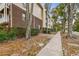 Brick and siding building exterior with landscaping and sidewalk at 1000 W Horatio St # 312, Tampa, FL 33606