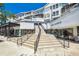 Modern building exterior with stairs leading to shops and businesses at 1000 W Horatio St # 312, Tampa, FL 33606