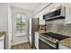 Stainless steel appliances and granite countertops in this updated kitchen at 1000 W Horatio St # 312, Tampa, FL 33606