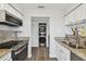 Open concept kitchen with stainless steel appliances and granite counters at 1000 W Horatio St # 312, Tampa, FL 33606