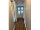 Hallway with wood flooring leading into a living area with tile flooring at 3409 E 9Th Ave, Tampa, FL 33605