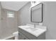 Updated bathroom with gray vanity and a tiled shower at 3206 N 29Th St, Tampa, FL 33605