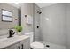 Modern bathroom with gray tile shower and white vanity at 6201 Cedarbrook N Dr, Pinellas Park, FL 33782