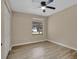 Spacious bedroom featuring wood-look floors and a ceiling fan at 6201 Cedarbrook N Dr, Pinellas Park, FL 33782