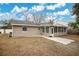 Tan house with a sunroom addition and backyard at 6201 Cedarbrook N Dr, Pinellas Park, FL 33782