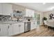 Modern white kitchen with stainless steel appliances and island at 6201 Cedarbrook N Dr, Pinellas Park, FL 33782