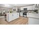 Modern white kitchen with stainless steel appliances and island at 6201 Cedarbrook N Dr, Pinellas Park, FL 33782