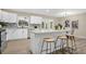 White kitchen island with seating for two and quartz countertop at 6201 Cedarbrook N Dr, Pinellas Park, FL 33782