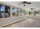 Sunroom with wood-look floors and multiple windows at 6201 Cedarbrook N Dr, Pinellas Park, FL 33782