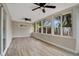 Sunroom with wood-look floors and large windows at 6201 Cedarbrook N Dr, Pinellas Park, FL 33782