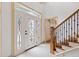 Bright entryway with elegant staircase and front door at 1001 Edgemont Pl, Brandon, FL 33511