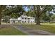 Two-story home with columns, light-colored siding, and a large driveway at 1001 Edgemont Pl, Brandon, FL 33511