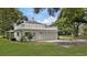 Rear view of a home showcasing a large garage with a deck above it at 1001 Edgemont Pl, Brandon, FL 33511