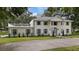 Two-story home with columns, light-colored siding, and a large driveway at 1001 Edgemont Pl, Brandon, FL 33511