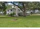 Side view of the house, showing a screened porch and lush landscaping at 1001 Edgemont Pl, Brandon, FL 33511