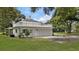 Rear view of a home showcasing a large garage with a deck above it at 1001 Edgemont Pl, Brandon, FL 33511