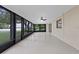 Bright sunroom with tiled floors, screens, and a ceiling fan at 1001 Edgemont Pl, Brandon, FL 33511