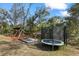 Spacious backyard with playset and trampoline at 3260 Wentworth St, North Port, FL 34288