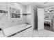 Elegant bathroom with soaking tub and marble tile at 3260 Wentworth St, North Port, FL 34288