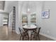 Bright breakfast nook with a glass-top table and metal chairs, overlooking the pool at 3260 Wentworth St, North Port, FL 34288