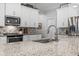 Granite countertop kitchen island with sink and modern faucet at 3260 Wentworth St, North Port, FL 34288