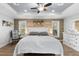 Large main bedroom with wood accent wall, king-size bed, and private access to patio at 3260 Wentworth St, North Port, FL 34288