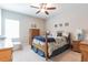 Bright bedroom featuring a wooden bed frame and neutral decor at 8726 Terracina Lake Dr, Tampa, FL 33625