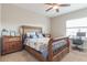 Bedroom with wood-framed bed and window seat at 8726 Terracina Lake Dr, Tampa, FL 33625