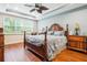 Spacious bedroom with wood flooring and a large bed at 8726 Terracina Lake Dr, Tampa, FL 33625