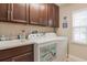 Laundry room with washer, dryer, and cabinets at 8726 Terracina Lake Dr, Tampa, FL 33625