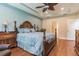 Main bedroom with light blue bedding and hardwood flooring. Access to bathroom at 8726 Terracina Lake Dr, Tampa, FL 33625